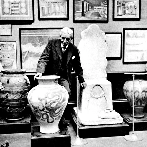 Sir Arthur Evans arranging exhibits, Burlington House, Londo