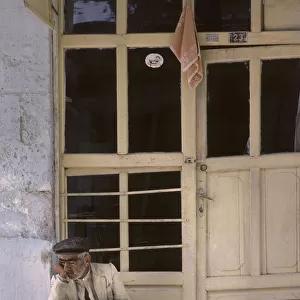 Sleeping old man on doorstep, Turkey