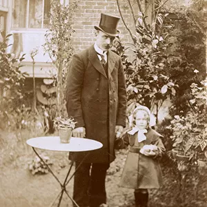 Smart Gentleman and young daughter in garden