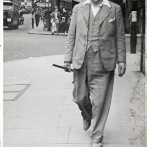 Smartly-dressed older man strolling along a London Street