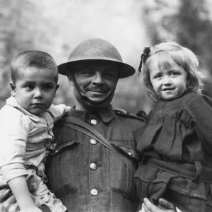 Soldier with two refugee children, Tournai, Flanders, WW1