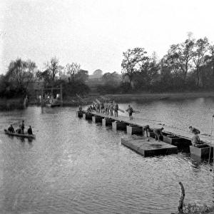 Soldiers constructing Bailey Bridge across river