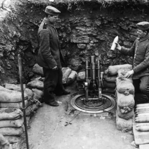 Two soldiers loading a mortar