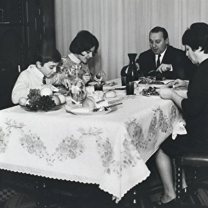 Spanish family sitting at the table at mealtime
