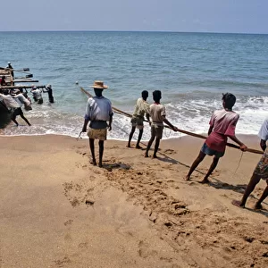 Sri Lankan beach fishermen hauling nets - 2