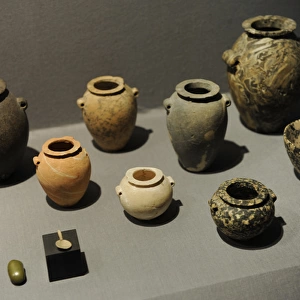 Stone jars and bowls with a small spoon and a small grinding