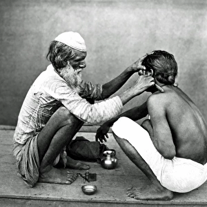 Street barber at work, India