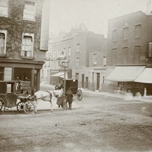 Street corner with horse-drawn carriages