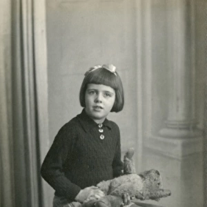 Studio photo of young girl and teddy bear
