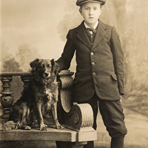 Studio portrait, boy with a dog