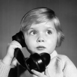 Studio portrait, little boy on the phone