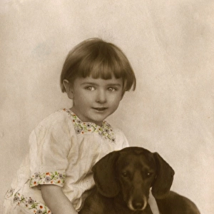 Studio portrait, little child with dachshund