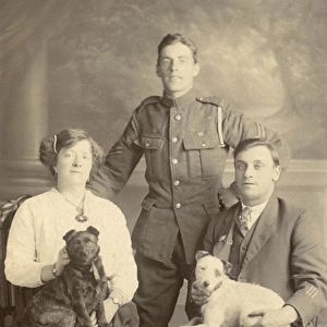 Studio portrait, three people with two dogs