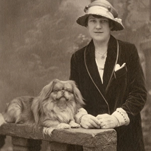 Studio portrait, woman with Pekingese dog