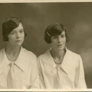 Studio portrait of two women, both with their dark hair bobbed