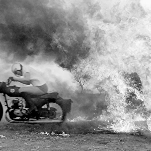 Stunt woman rides through flames on motorbike