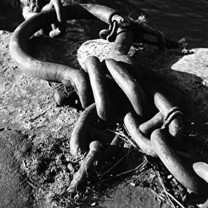 A sturdy chain tie-ring for mooring boats at a quayside. Date: 1950s