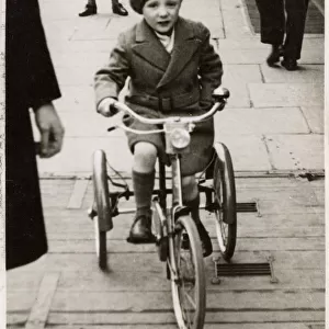 Sunny Snaps - London - Young boy on a Tricycle