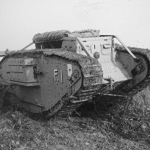 Tank breaking through barbed wire barricade