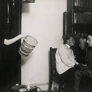 Teleplasmic hand holding basket at a seance