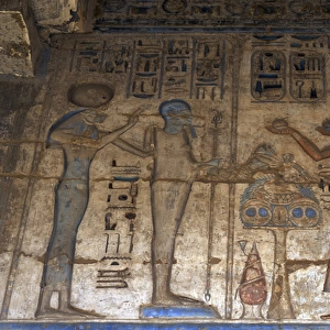 Temple of Ramses III. The pharaoh making offerings before go