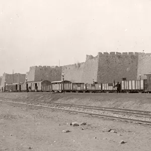 Train at Peking, Beijing city walls, China, c. 1900