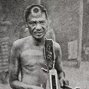 Tribesman playing tattoo, French Congo, Central Africa