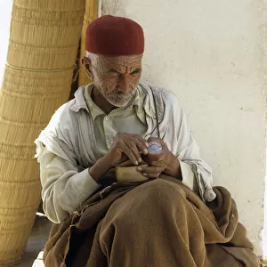Tunisian man sits in shade