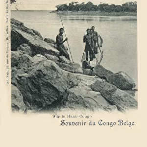 Upper Congo, Africa - Four tribesmen and their dugout canoe