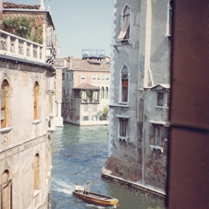 View of a canal through a window, Venice, Italy