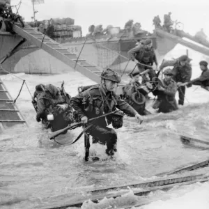 Wading ashore from landing craft at Ouistreham and Bernieres