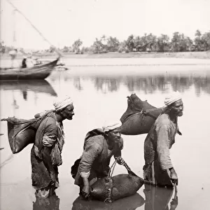 Water carriers filling bags in the River Nile, Egypt, c. 1880 s