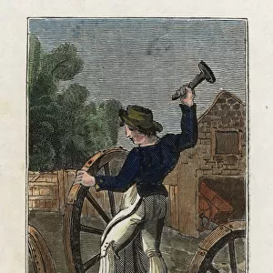 Wheelwright hammering a metal cover onto a