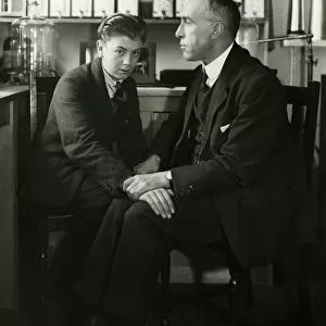 Willi Schneider when young seated with Harry Price