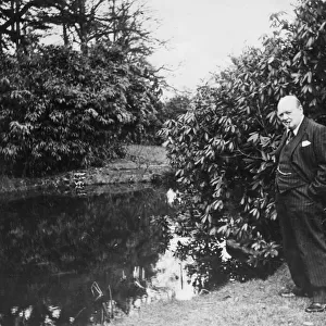 Winston Churchill by a lake at Chartwell