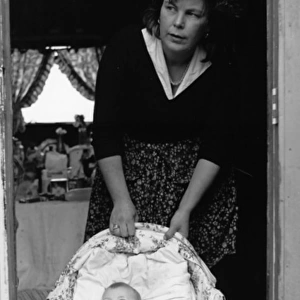 Woman with a baby in a cottage doorway