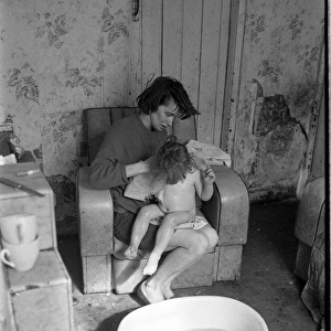 Woman bathing baby, Falls Road, Northern Ireland