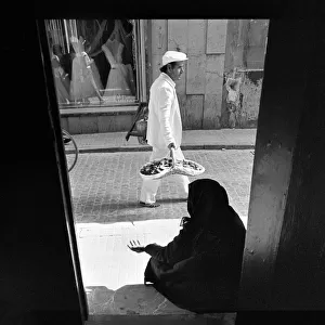A woman beggar sits in a church doorway, Cadiz, Spain