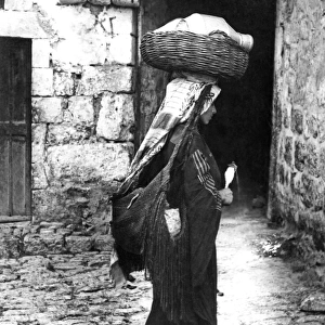 Woman carrying basket, Jerusalem