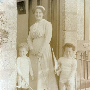 Woman with her two children and a Scottish Terrier