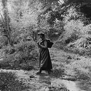 Woman crossing a brook, 1890s