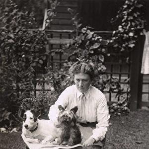 Woman with three dogs in the garden