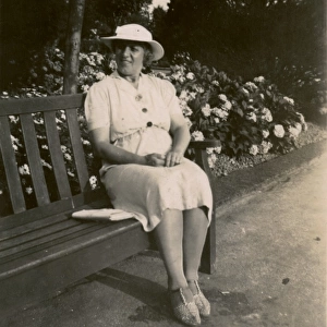 Woman on holiday, sitting on a bench