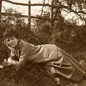 Woman lying on grass in a field