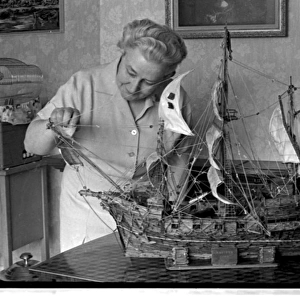 Woman with model ship made of matchsticks