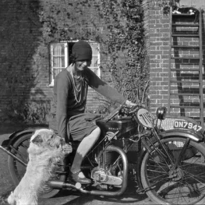 Woman on a motorbike with a dog