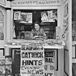Woman in newspaper kiosk