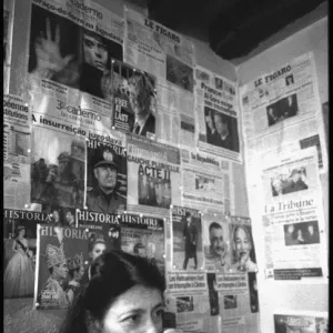 Woman in Paris cafe - walls covered in political posters