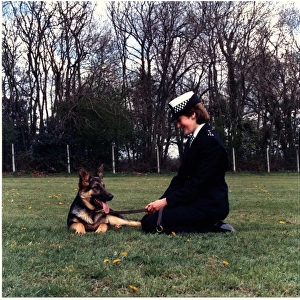 Woman police dog handler with dog, London