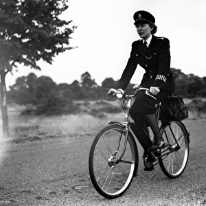 Woman police officer on bicycle, Met Police